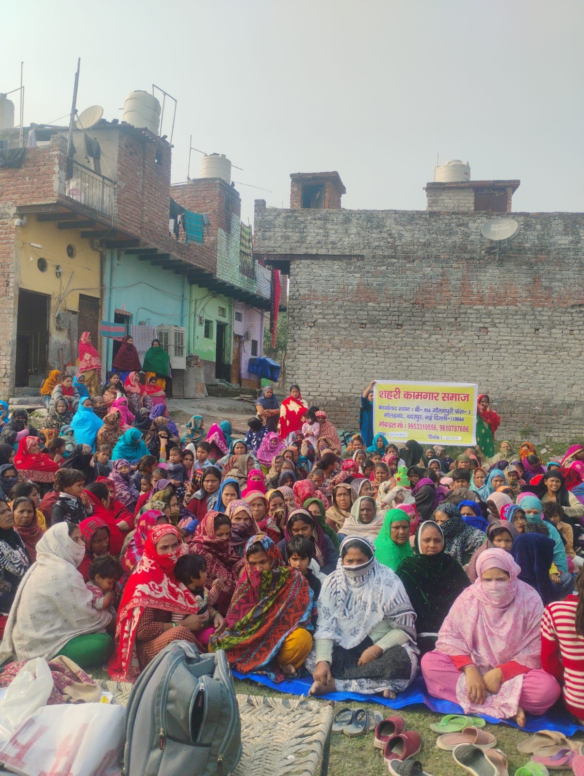 Women seated together during a community support meeting led by Shehri Kamgar Samaj.